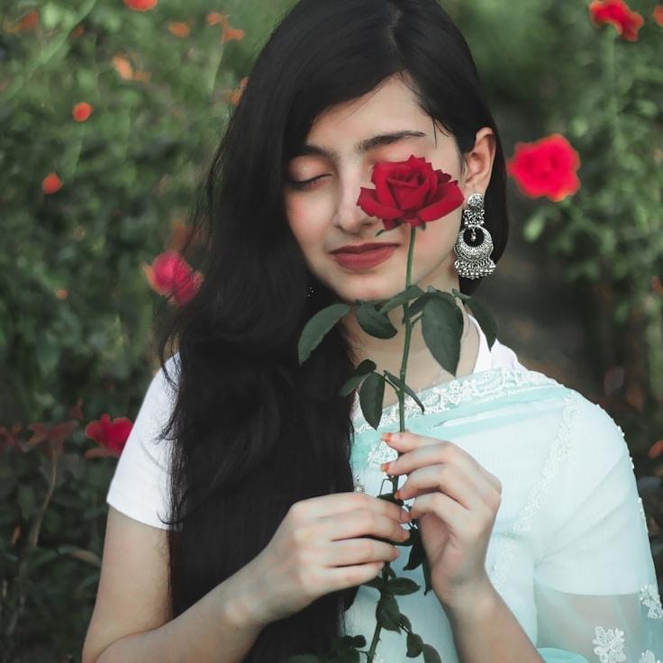 Asha Rao, Lead Design Curator at Bright Cabin Path, reviewing corporate floral arrangements